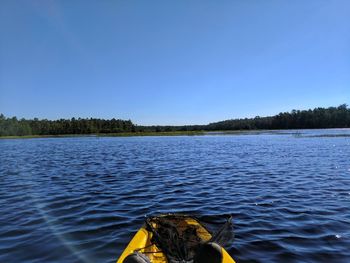 Scenic view of river against clear blue sky