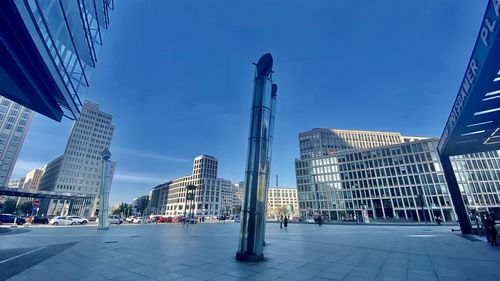 Buildings in city against blue sky