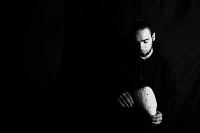 Portrait of young man in darkroom