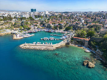 High angle view of city by sea against sky