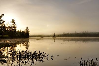 Scenic view of lake against sky during sunset