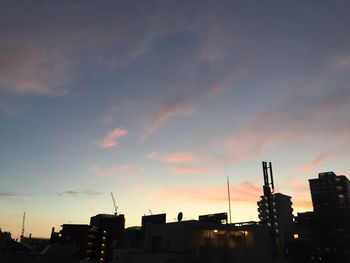 Buildings in city at sunset