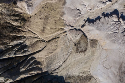 Aerial shot of abandoned opencast mine. abstract cracked mud pattern, erosion, bad land from a drone