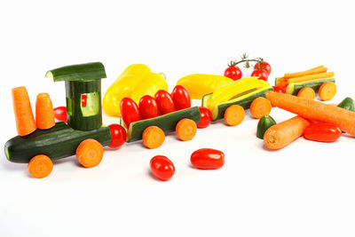 Close-up of multi colored bell peppers on white background