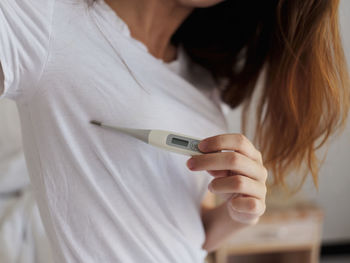 Midsection of woman using mobile phone