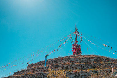 Low angle view of mountain against clear blue sky