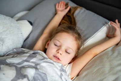 Portrait of boy sleeping on bed at home