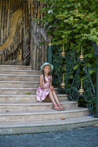 The girl is sitting on the steps