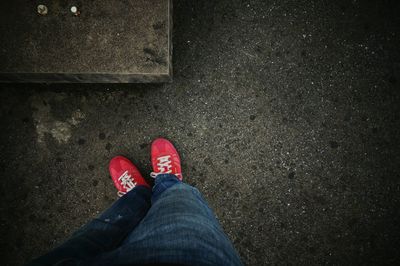 Low section of person standing on tiled floor
