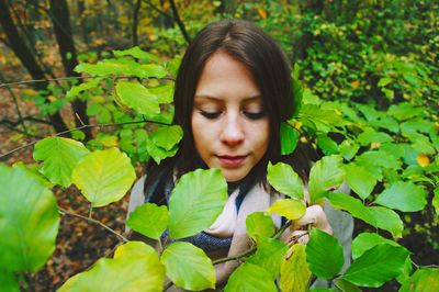 Portrait of woman with green plants