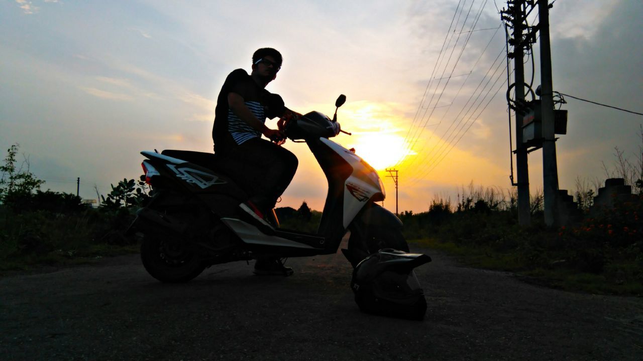 leisure activity, sky, sunset, full length, one person, low angle view, real people, men, road, adults only, outdoors, only men, young adult, one man only, headwear, people, biker, adult, day