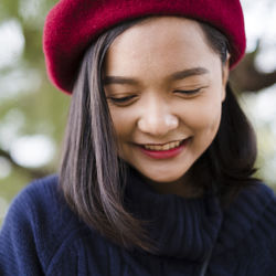 Close-up portrait of a smiling young woman in winter