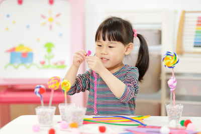 Cute girl playing with toy at home