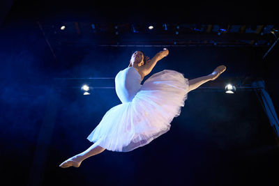 Low angle view of woman dancing on stage