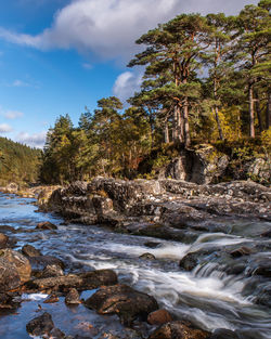 Scenic view of waterfall against sky