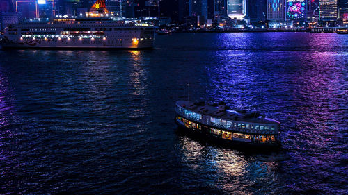 Boat sailing in river at night