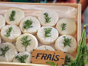 Close-up of cheese with herbs in box at market