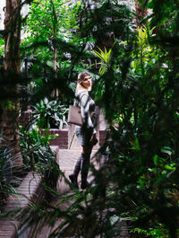 Full length of woman standing against trees