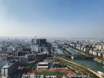 High angle view of river and buildings against clear sky