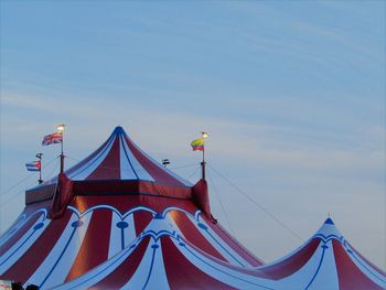 Low angle view of flags against blue sky