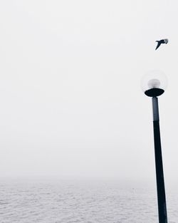Calm sea against clear sky