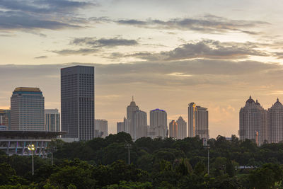 Cityscape against sky during sunset