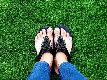 Low section of woman standing on grass