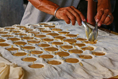 Midsection of man making sweet food