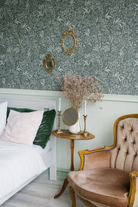 Interior of the scandinavian provence bedroom. pillows on the bed, a wooden table on a leg