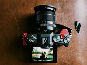 Close-up of camera on table against wall