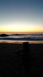 Scenic view of beach against sky during sunset