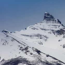 Low angle view of snowcapped mountain against sky