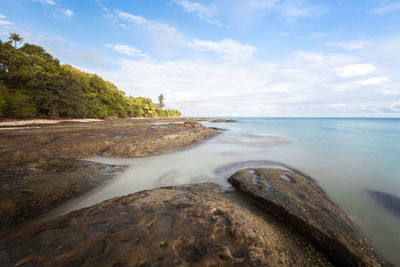 Jungle beach, stony coast. long exposure capture of coast and ocean on borneo, sabah - malaysia
