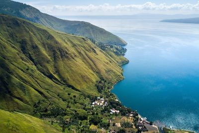 High angle view of sea and mountains against sky