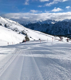 Scenic view of snow covered mountains against sky