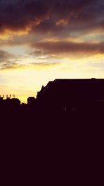 Silhouette of built structure at sunset