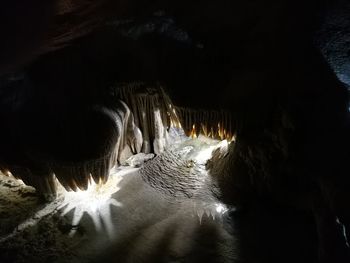 Illuminated cave in snow