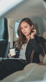 Portrait of woman with coffee cup