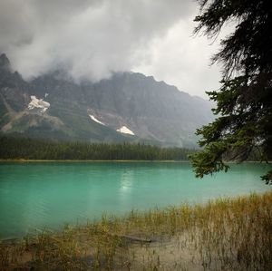 Scenic view of lake and mountains against sky