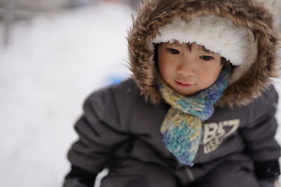 Portrait of young woman standing on snow