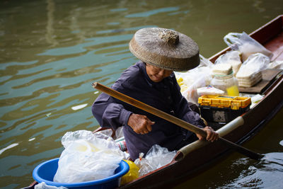 Man sitting on boat in lake