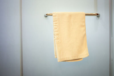 Clean white hand towel on a hanger.