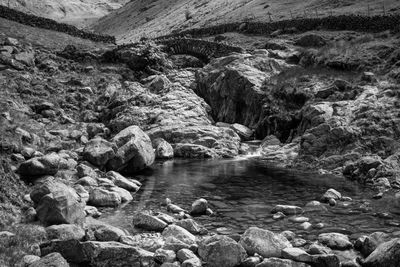 River flowing under bridge and through rocks