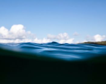 Surface level of sea against blue sky