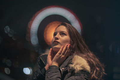 Portrait of young woman smoking outdoors