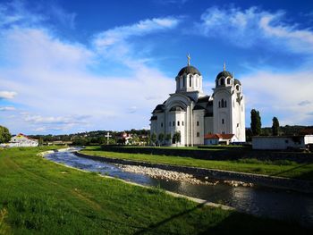 Church by building against sky