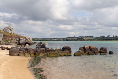 Dolmen guinirvit, ruins in the sea, bay of kernic, plouescat, brittany, france