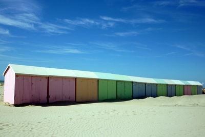 Built structure on beach against blue sky