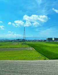 Windmill on field against sky