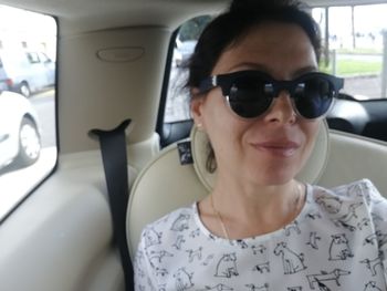 Portrait of man wearing sunglasses in car